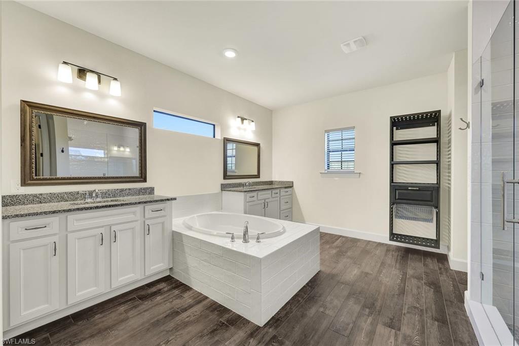 19176 Elston Way Estero, FL 33928 - Photo 13 of 26 a bathroom with a tub sink and mirror