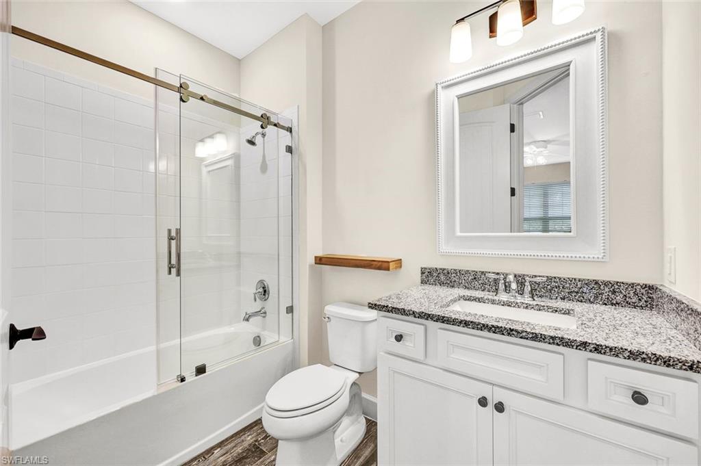 19176 Elston Way Estero, FL 33928 - Photo 15 of 26 a bathroom with a granite countertop sink toilet and shower