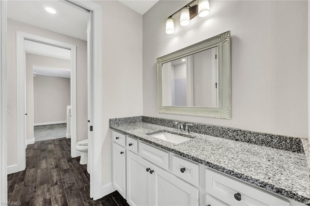 19176 Elston Way Estero, FL 33928 - Photo 19 of 26 a bathroom with a granite countertop sink and a mirror