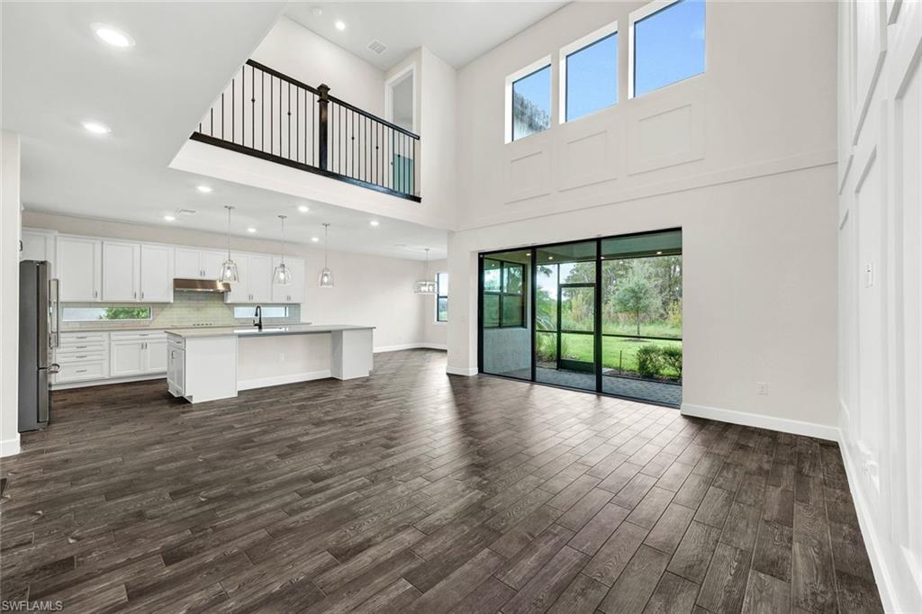 19176 Elston Way Estero, FL 33928 - Photo 2 of 26 a view of an empty room with wooden floor and a window
