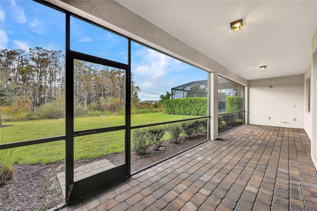 19176 Elston Way Estero, FL 33928 - Photo 25 of 26 a view of balcony with floor to ceiling windows yard