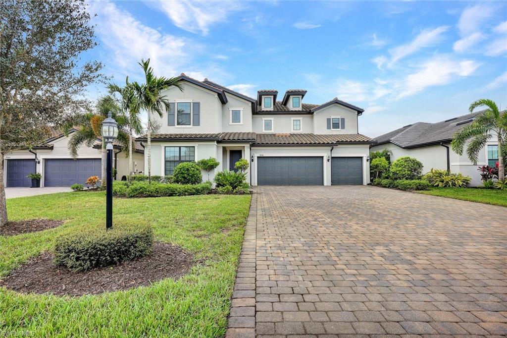 19176 Elston Way Estero, FL 33928 - Photo 26 of 26 a front view of a house with a yard and garage