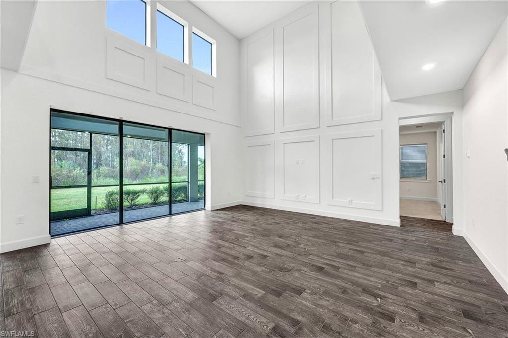 19176 Elston Way Estero, FL 33928 - Photo 3 of 26 a view of an empty room with wooden floor and a window