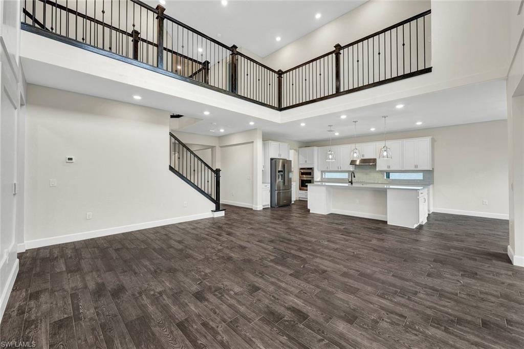 19176 Elston Way Estero, FL 33928 - Photo 4 of 26 a view of a hallway with a kitchen