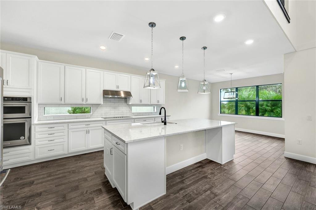 19176 Elston Way Estero, FL 33928 - Photo 7 of 26 a kitchen with a sink window and cabinets