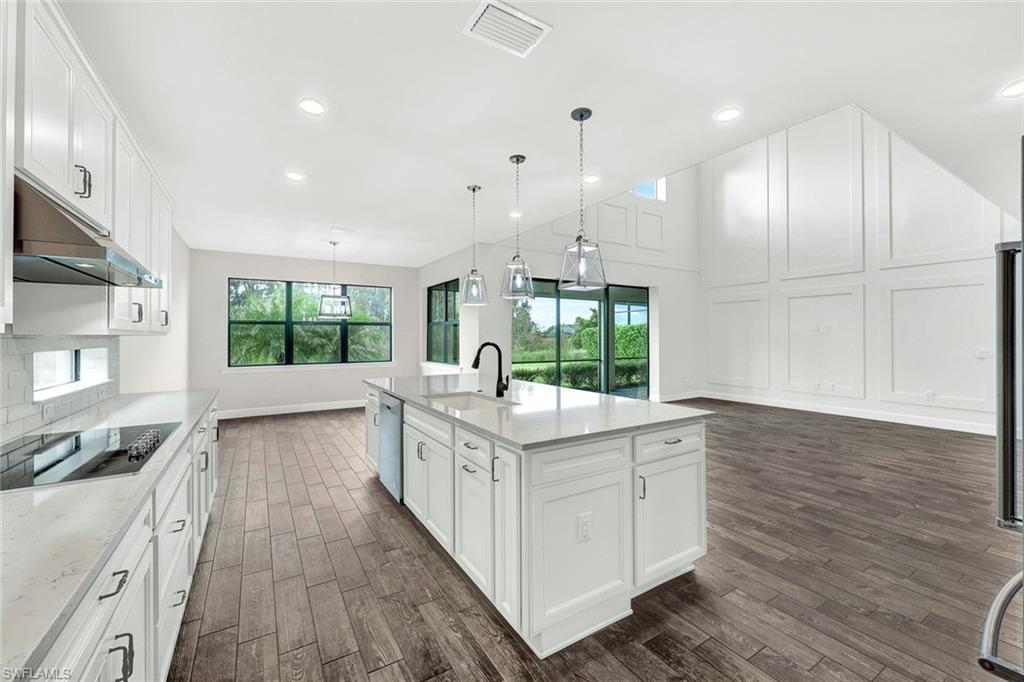 19176 Elston Way Estero, FL 33928 - Photo 8 of 26 a kitchen with stainless steel appliances granite countertop a stove and a wooden floors