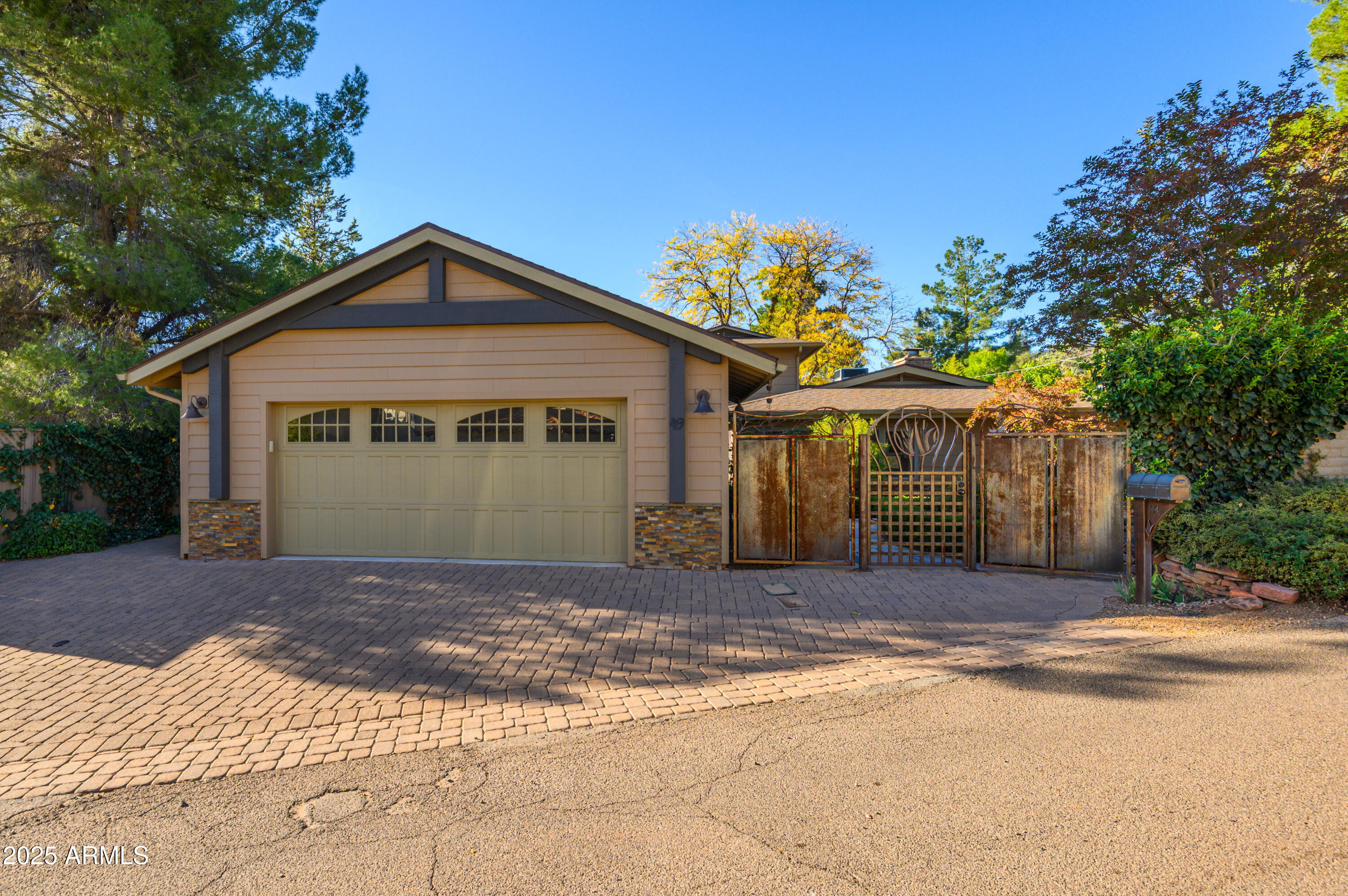 49 Prochnow Road Sedona, AZ 86336 - Photo 72 of 76 a front view of a house with a yard and garage