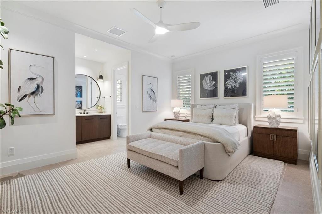 4220 Crayton Road Naples, FL 34103 - Photo 13 of 27 a spacious bedroom with a large bed and ceiling fan
