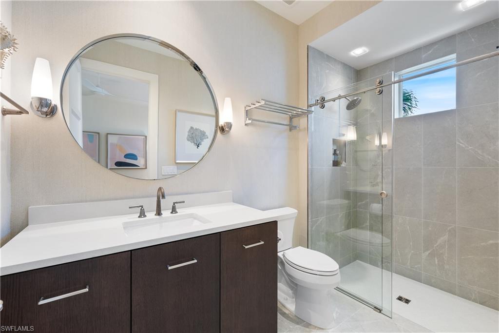 4220 Crayton Road Naples, FL 34103 - Photo 18 of 27 a bathroom with a sink a toilet and shower