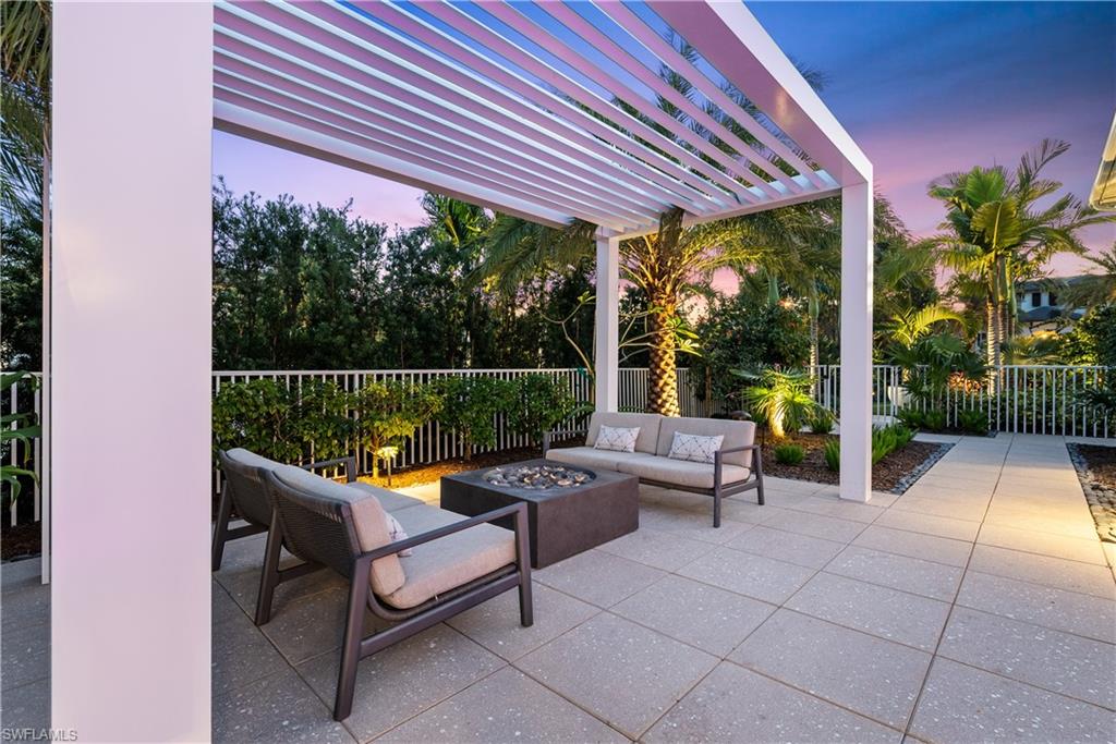 4220 Crayton Road Naples, FL 34103 - Photo 24 of 27 a balcony with furniture and a potted plant
