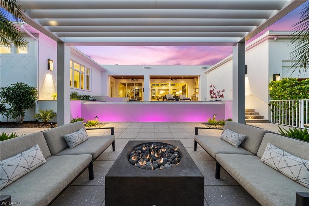 4220 Crayton Road Naples, FL 34103 - Photo 25 of 27 a living room with furniture and a potted plant