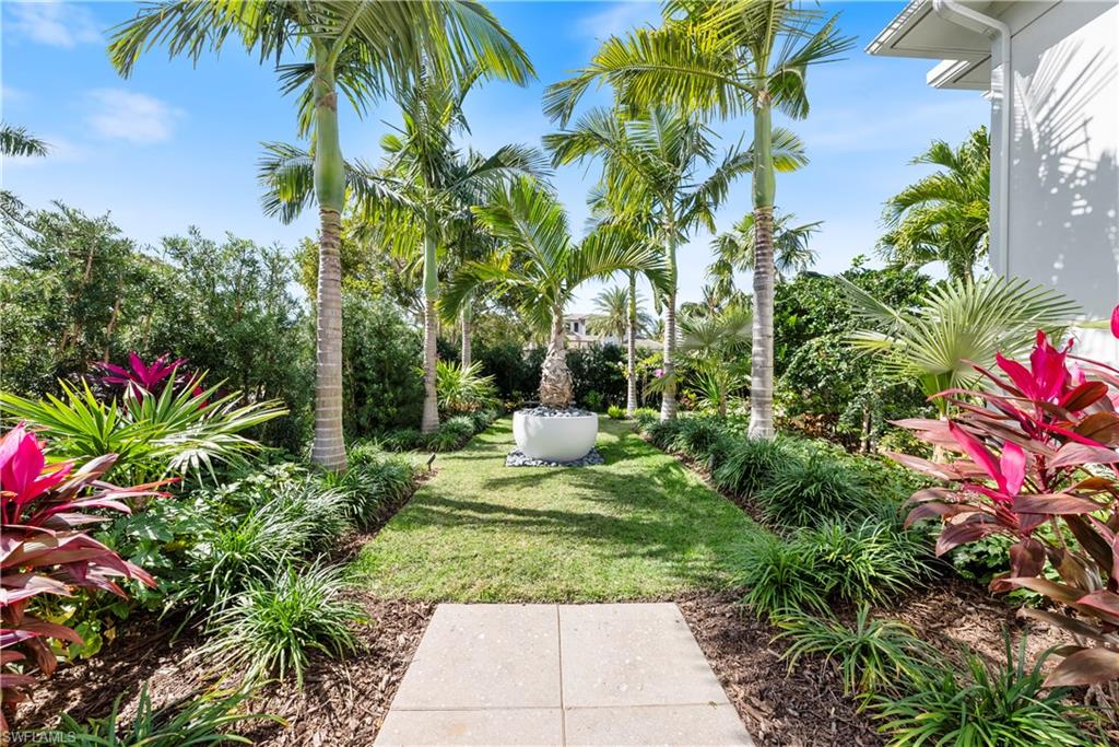 4220 Crayton Road Naples, FL 34103 - Photo 26 of 27 a view of a garden with plants and a fountain