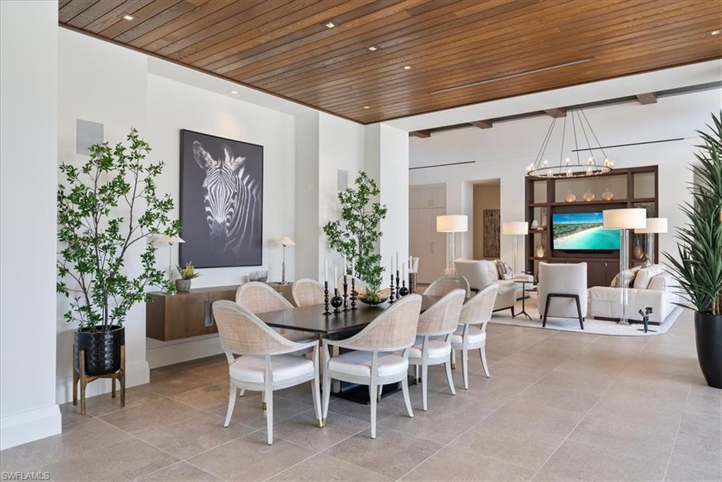 4220 Crayton Road Naples, FL 34103 - Photo 4 of 27 a view of a dining room with furniture and chandelier