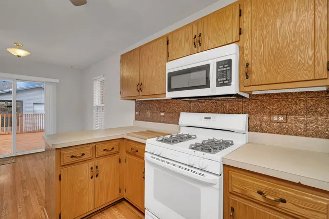 a kitchen with granite countertop cabinets stainless steel appliances and wooden cabinets
