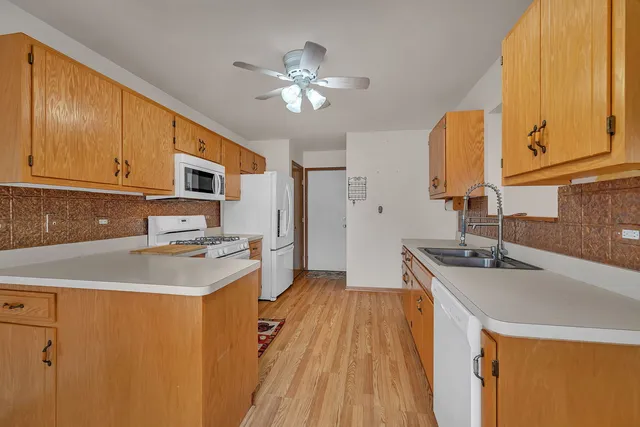 a kitchen with stainless steel appliances a sink stove and refrigerator