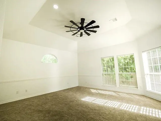 a view of a livingroom with a window and a ceiling fan