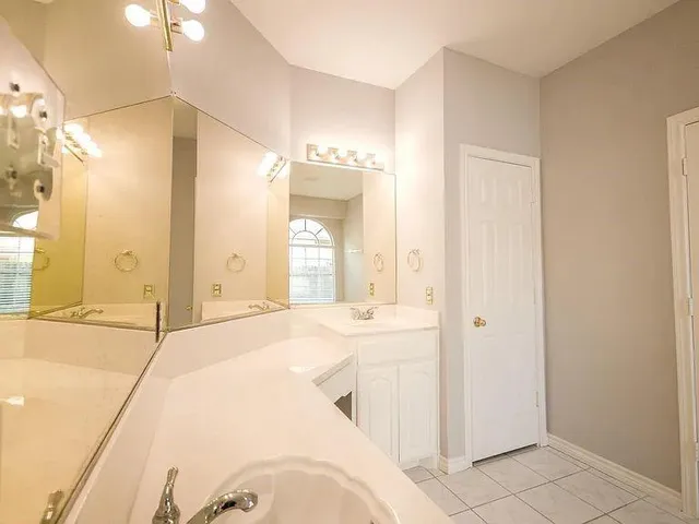 a bathroom with a tub sink and mirror