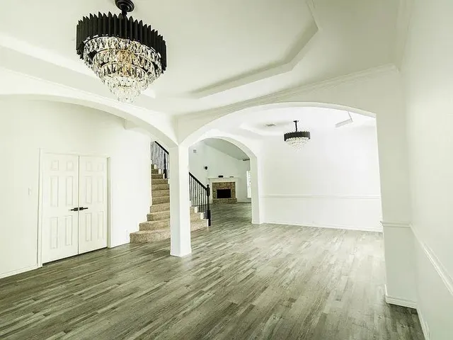 a view of a hallway with wooden floor