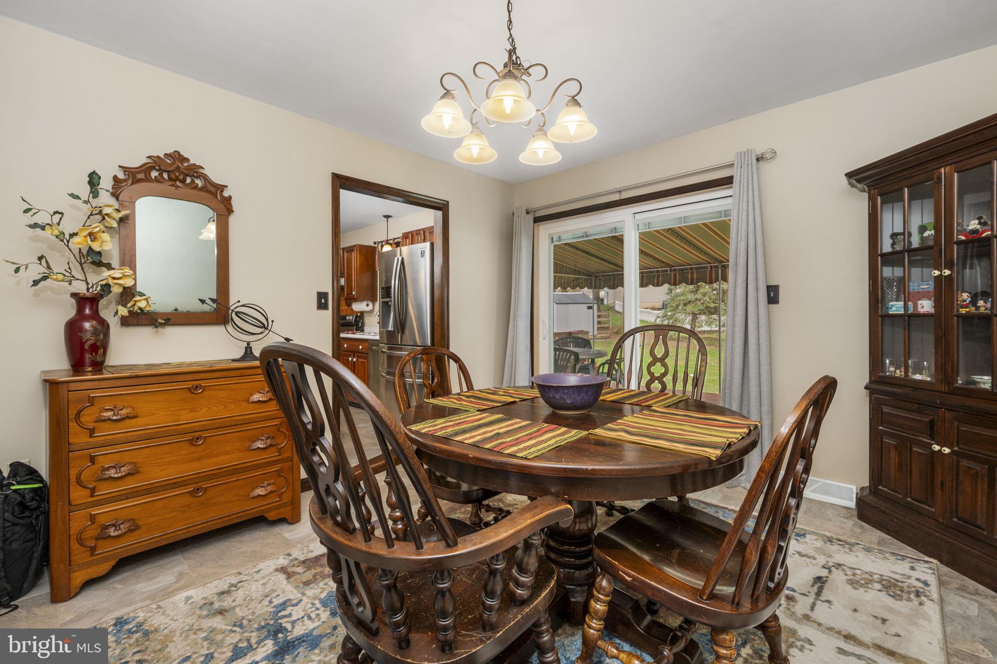 558 Crosswinds Drive Lititz, PA 17543 - Photo 11 of 31 a view of a dining room with furniture and a chandelier