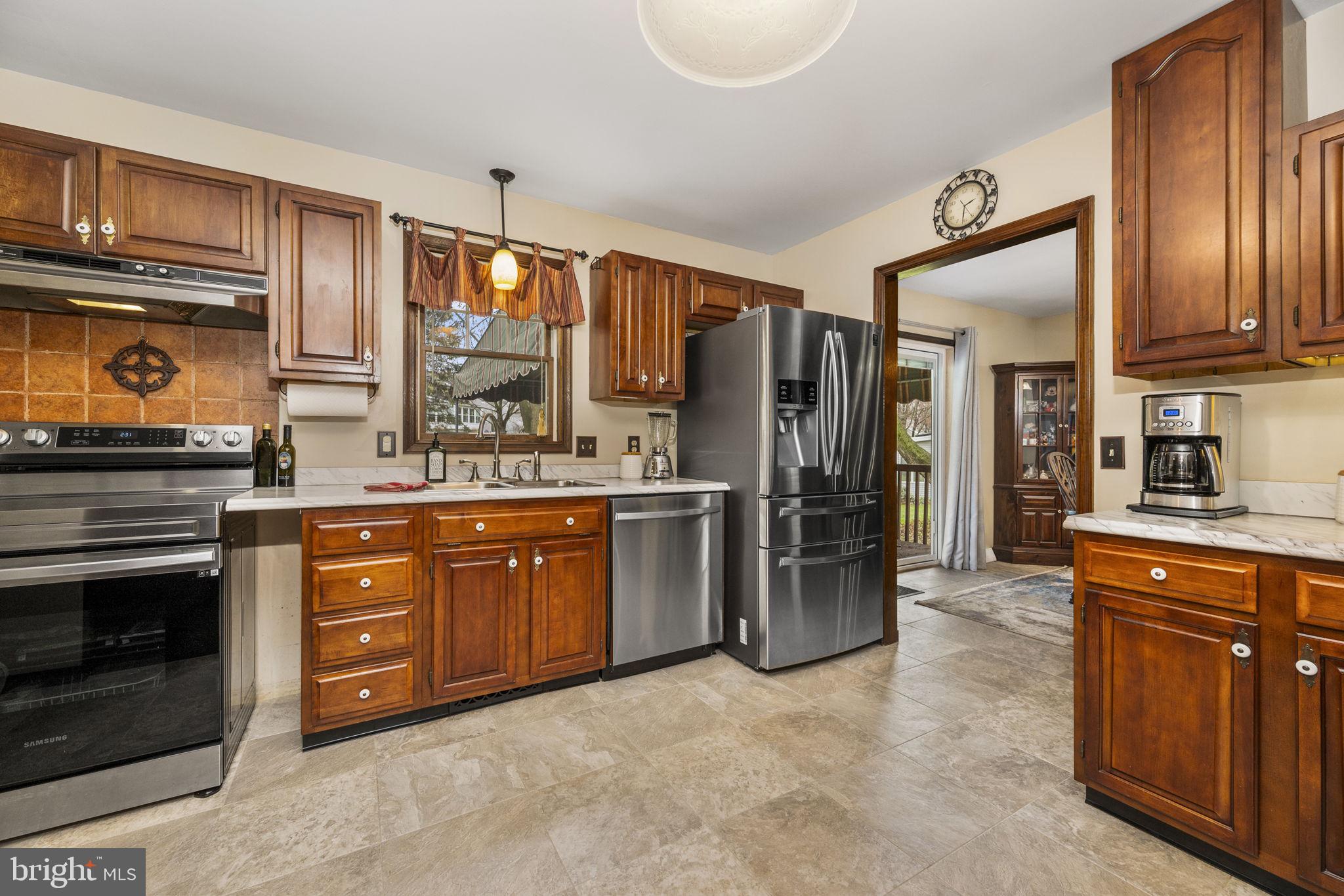 558 Crosswinds Drive Lititz, PA 17543 - Photo 7 of 31 a kitchen with stainless steel appliances granite countertop a refrigerator a stove and sink