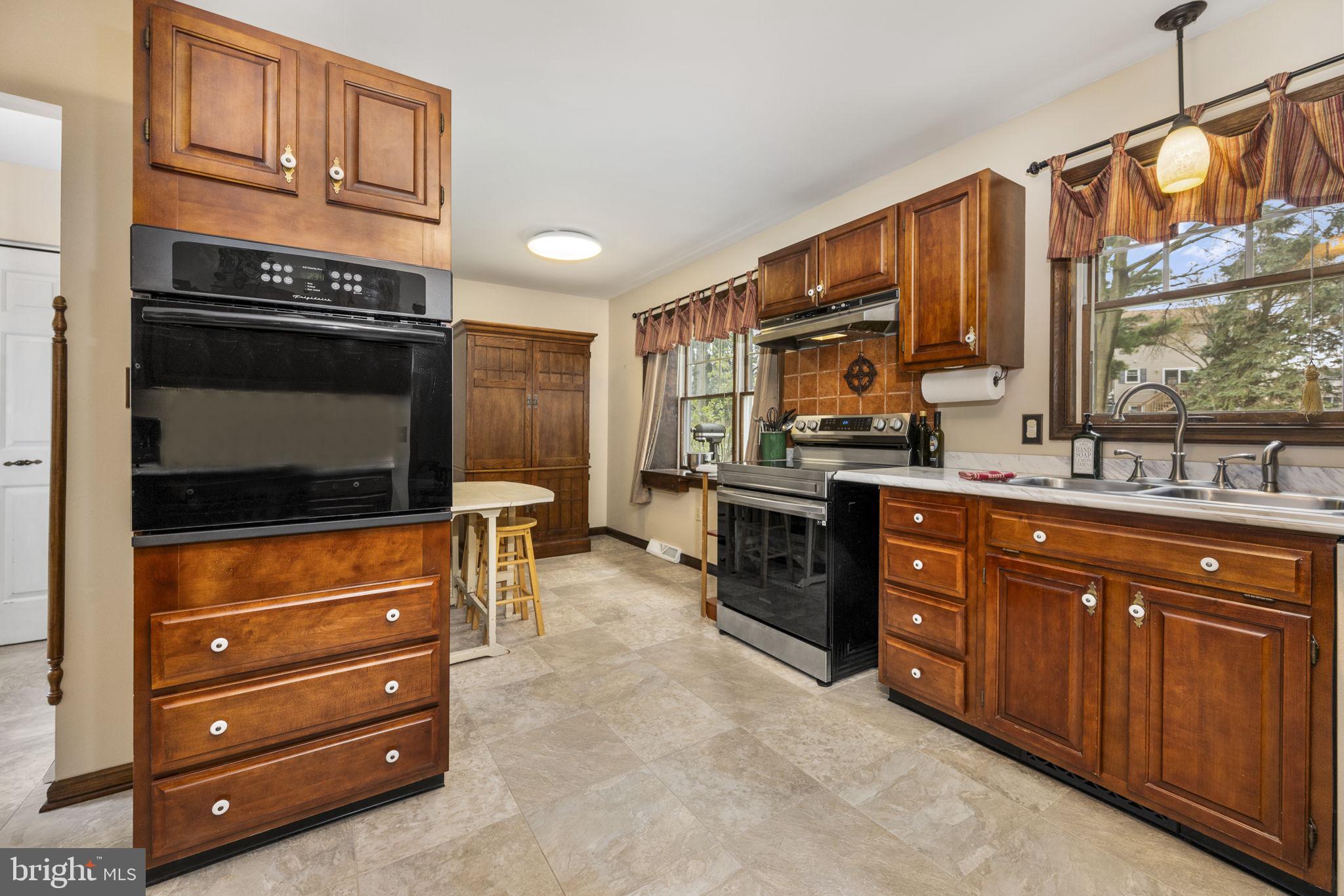558 Crosswinds Drive Lititz, PA 17543 - Photo 9 of 31 a kitchen with stainless steel appliances granite countertop a stove and a sink