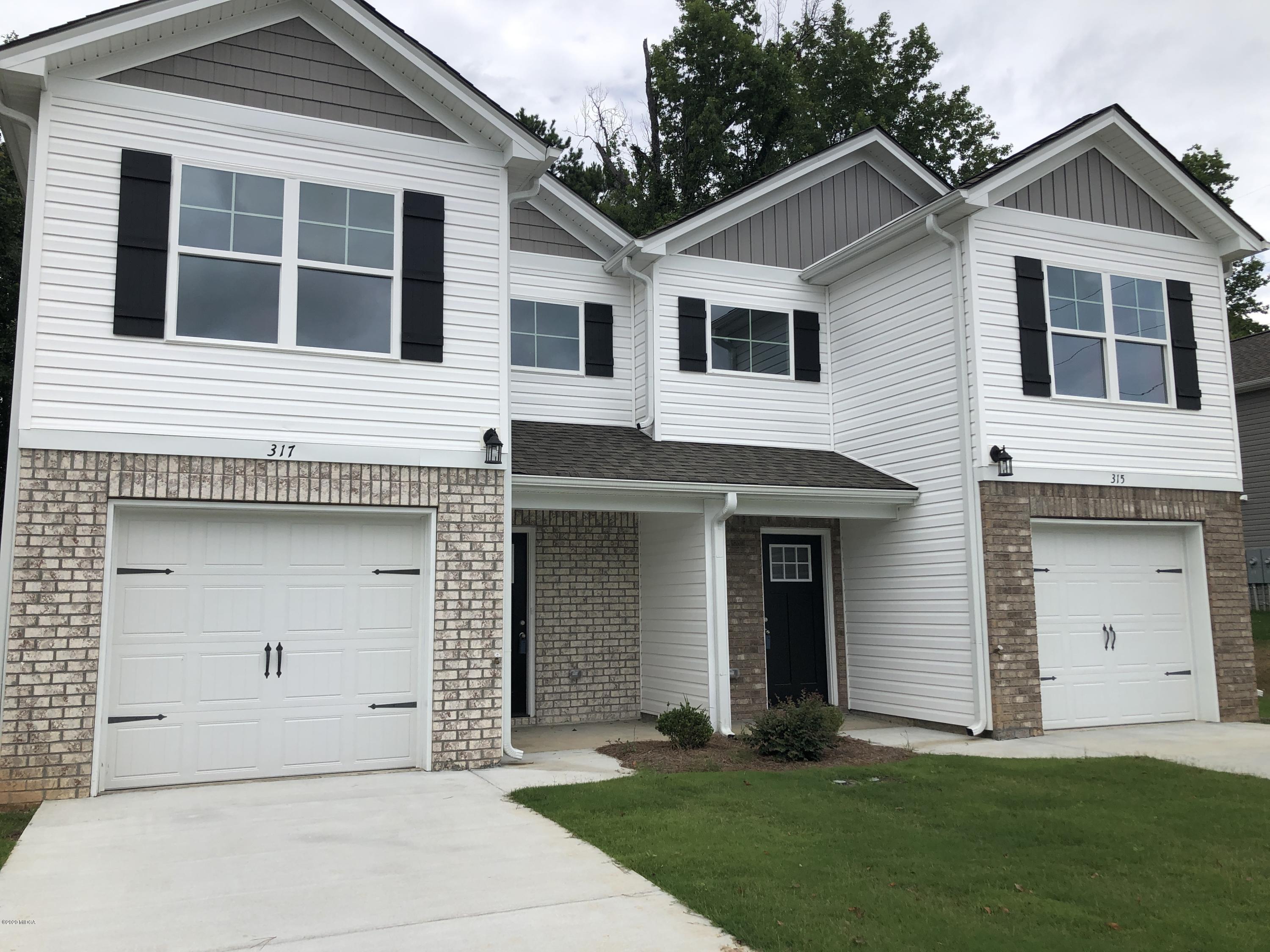317 Pond View Road Macon, GA 31206 - Photo 1 of 28 a front view of a house with a yard and garage
