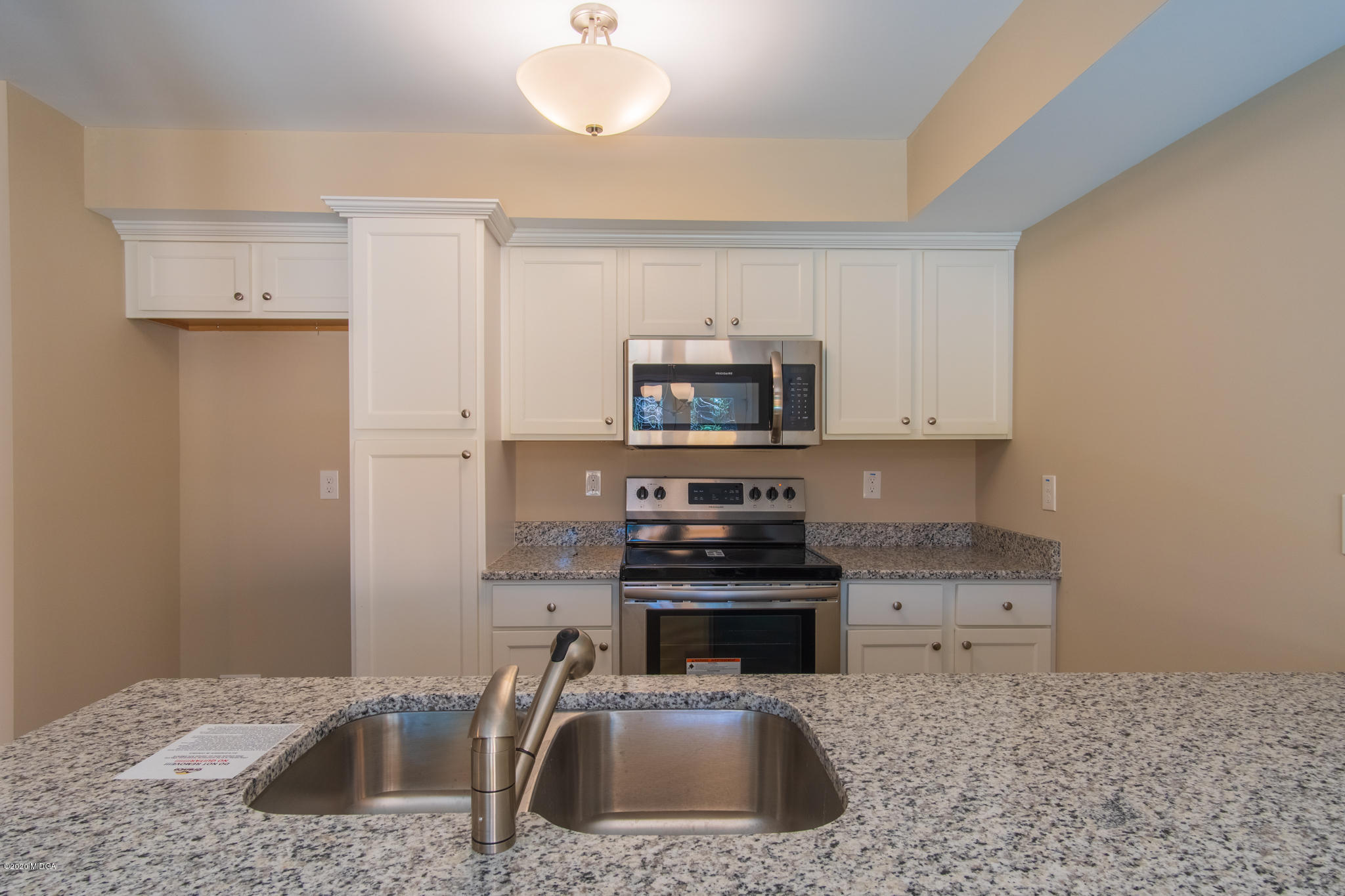 317 Pond View Road Macon, GA 31206 - Photo 5 of 28 a kitchen with stainless steel appliances a sink a stove a microwave a counter top space and cabinets