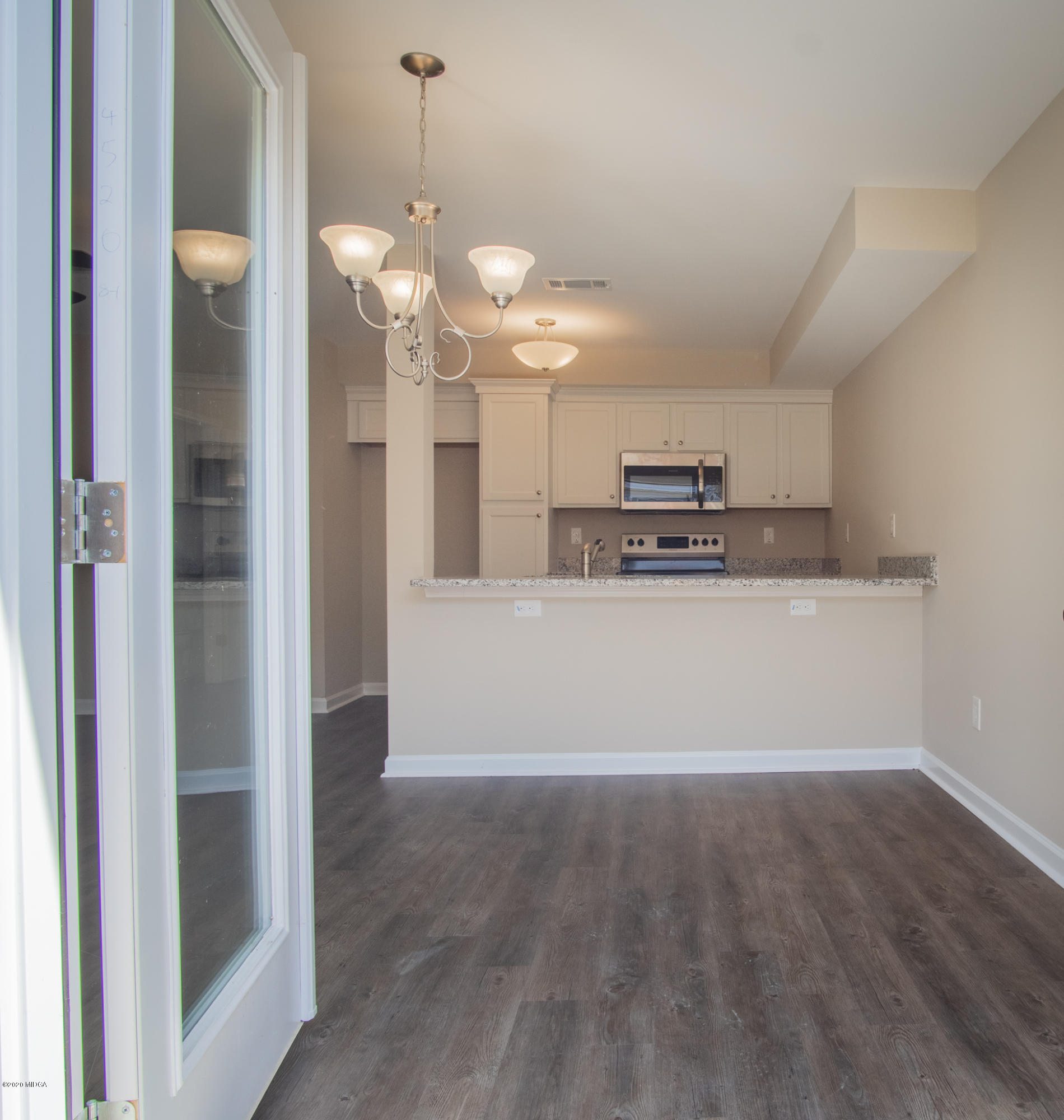 317 Pond View Road Macon, GA 31206 - Photo 9 of 28 a view of a kitchen with a sink and dishwasher a refrigerator with wooden floor