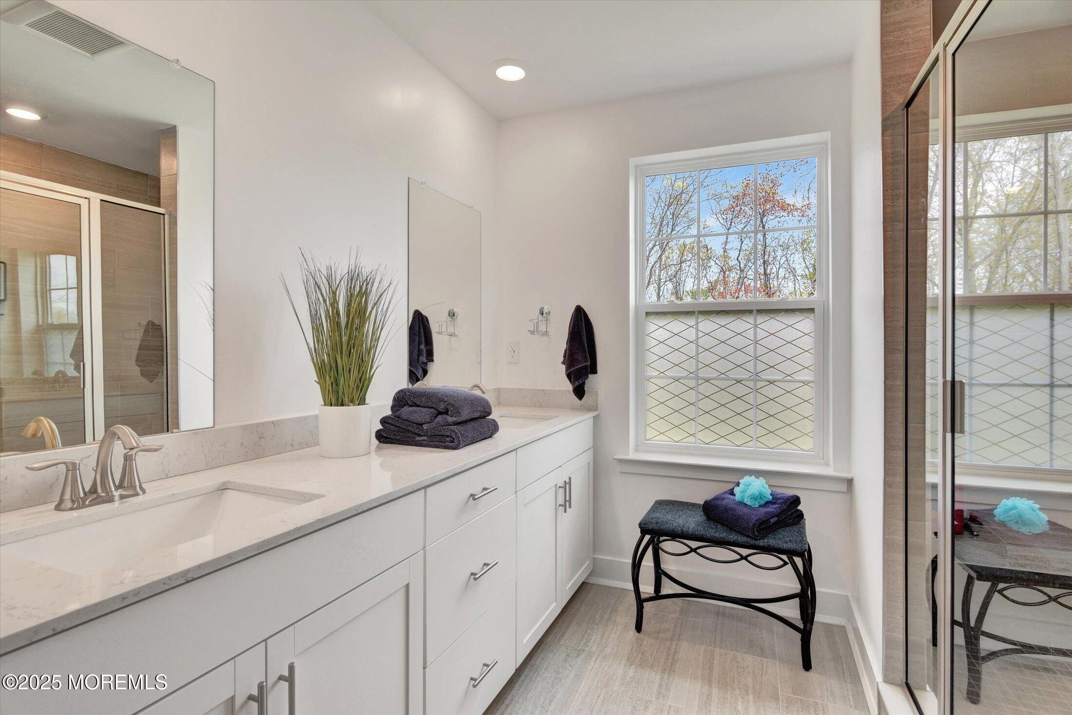 105 Pilot Street Marlboro, NJ 07746 - Photo 11 of 30 a en suite bathroom with double vanity and a window