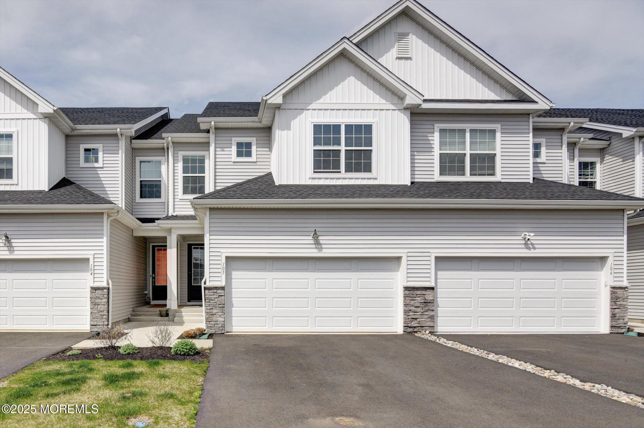 105 Pilot Street Marlboro, NJ 07746 - Photo 2 of 30 a front view of a house with a yard and garage