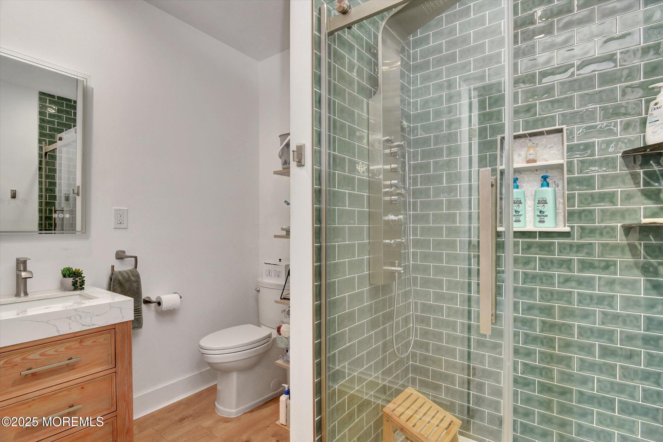 105 Pilot Street Marlboro, NJ 07746 - Photo 22 of 30 a bathroom with a toilet a sink and shower