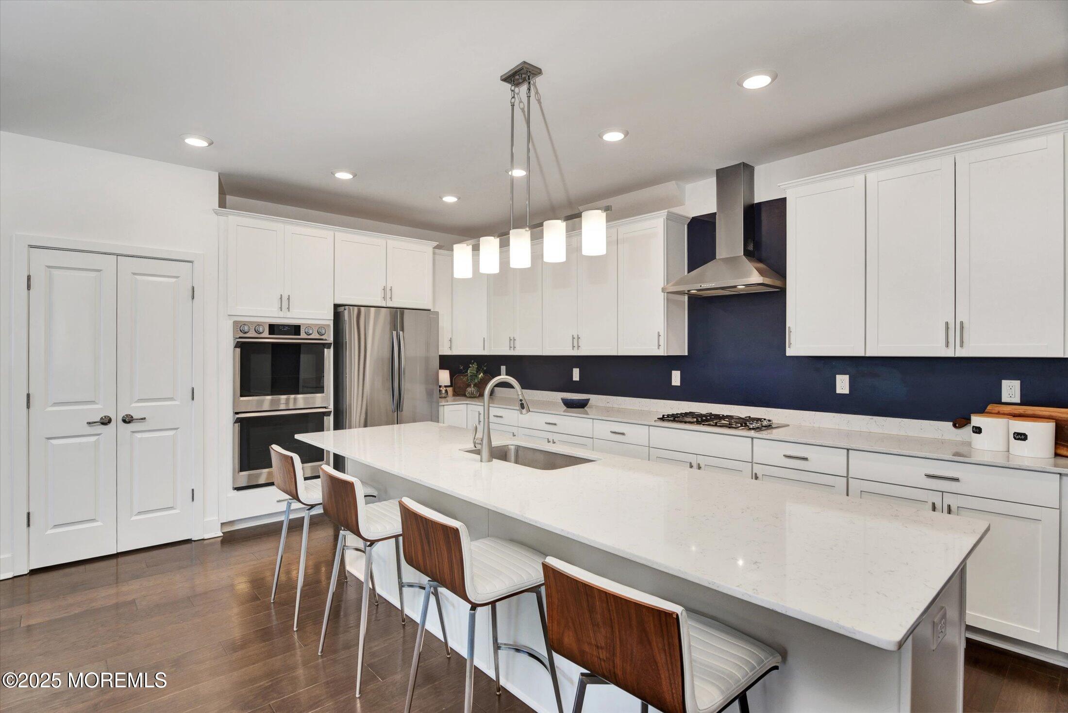 105 Pilot Street Marlboro, NJ 07746 - Photo 6 of 30 a kitchen with kitchen island a stove a table and chairs in it