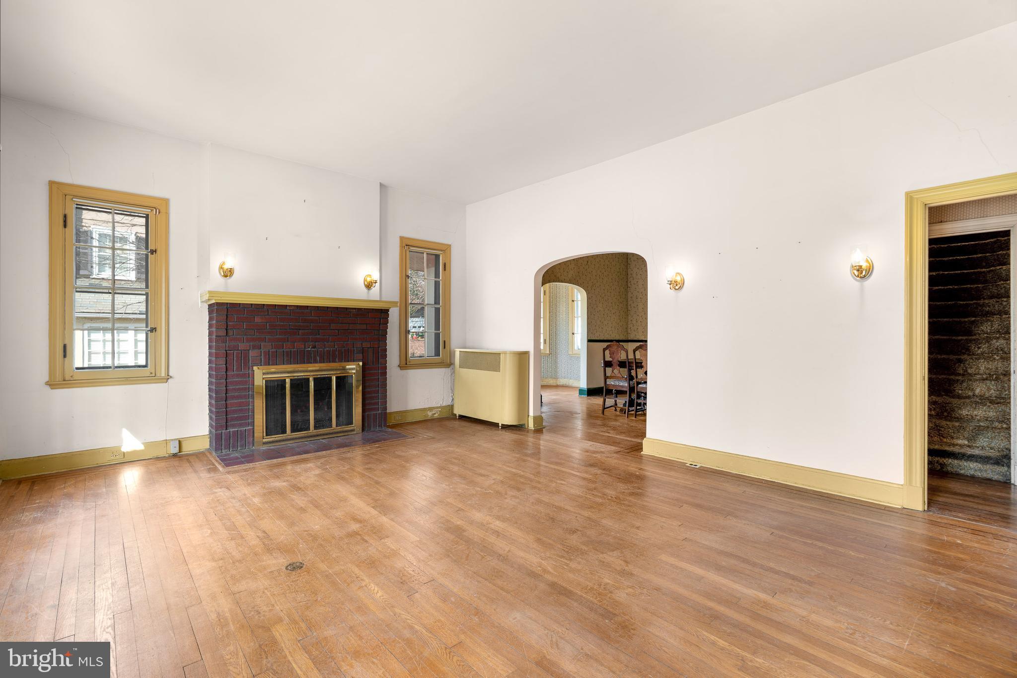 513 Stamford Road Baltimore, MD 21229 - Photo 4 of 20 a view of empty room with fireplace and wooden floor