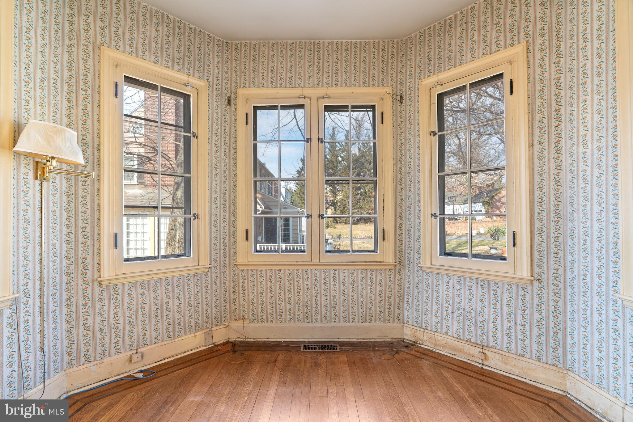 513 Stamford Road Baltimore, MD 21229 - Photo 8 of 20 an empty room with wooden floor and windows