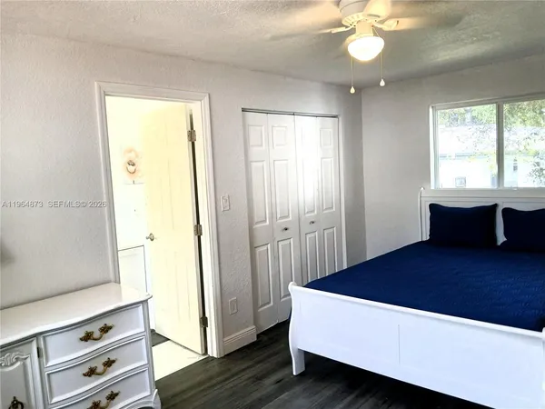 a living room with a bed furniture and a window