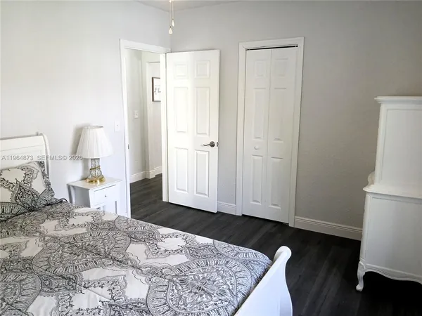 a view of a bedroom with wooden floor and bedroom space