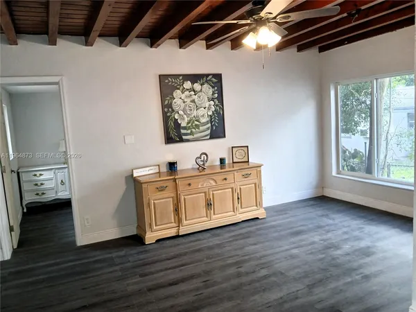 a view of a room with wooden floor