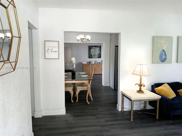 a dining room with furniture and wooden floor