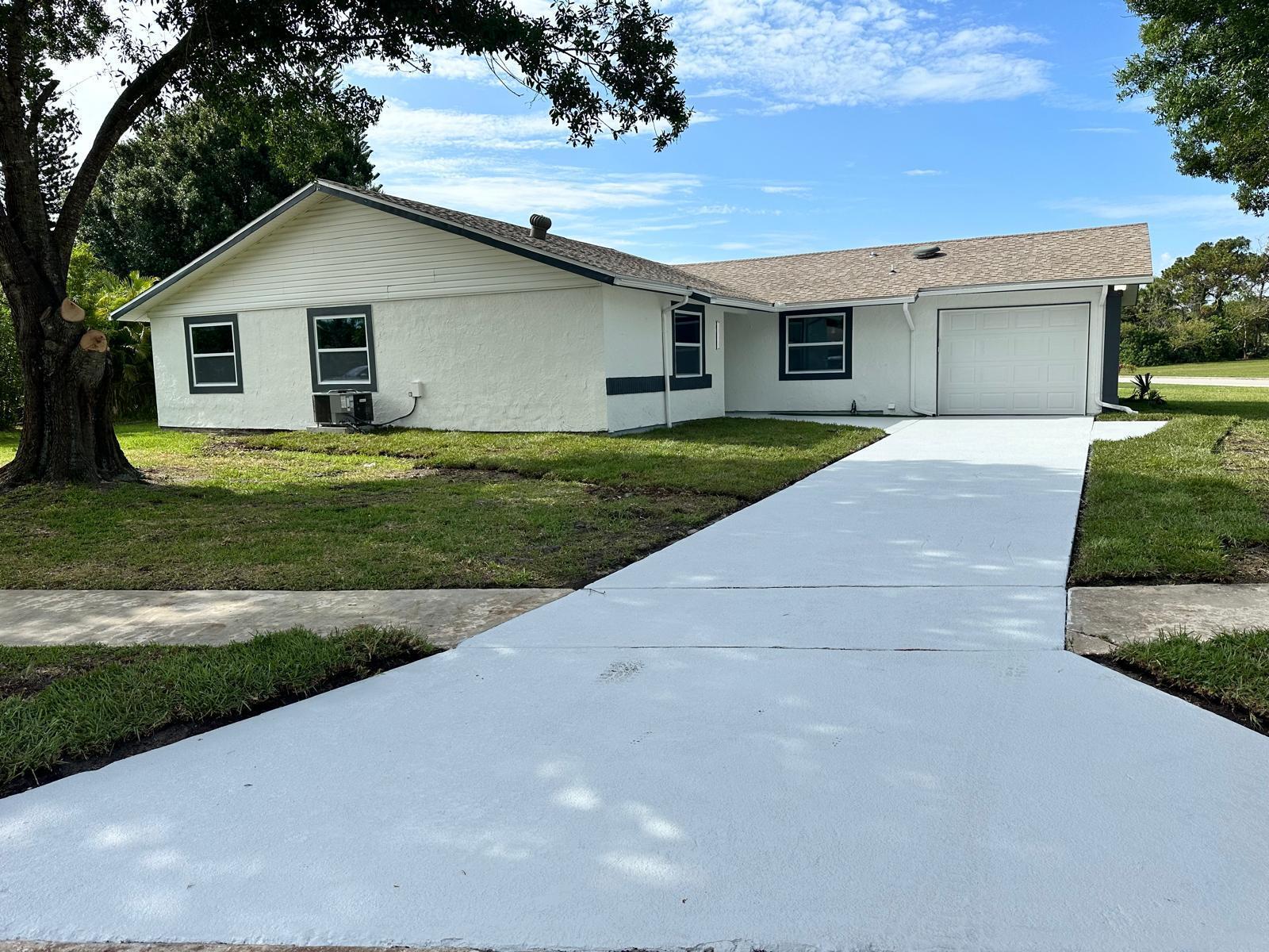 1398 Cromey Road Northeast Palm Bay, FL 32905 - Photo 1 of 36 a front view of house with yard and green space