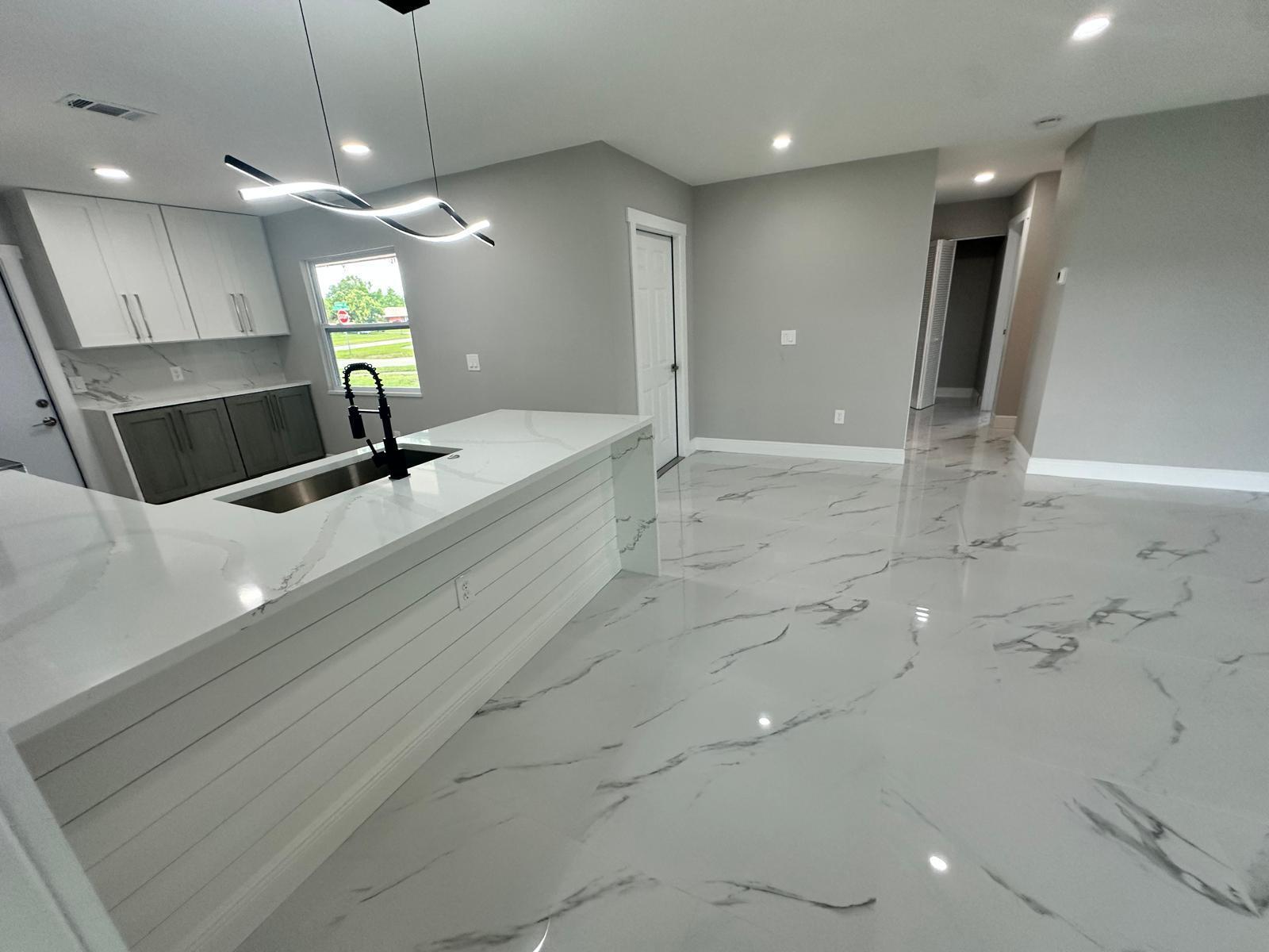 1398 Cromey Road Northeast Palm Bay, FL 32905 - Photo 7 of 36 a large room with kitchen view
