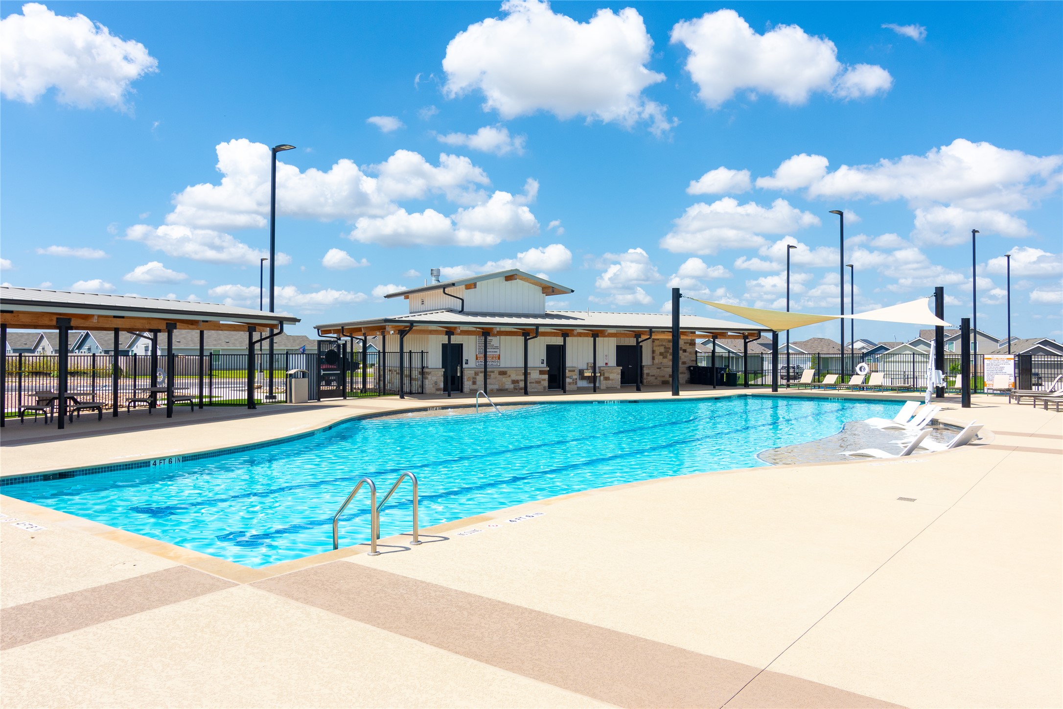 548 Rancho Del Cielo Loop Jarrell, TX 76537 - Photo 34 of 40 Community swimming pool with dedicated lap lanes, expansive deck space, and a shaded pavilion