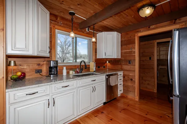 a bathroom with a granite countertop sink a toilet and a mirror