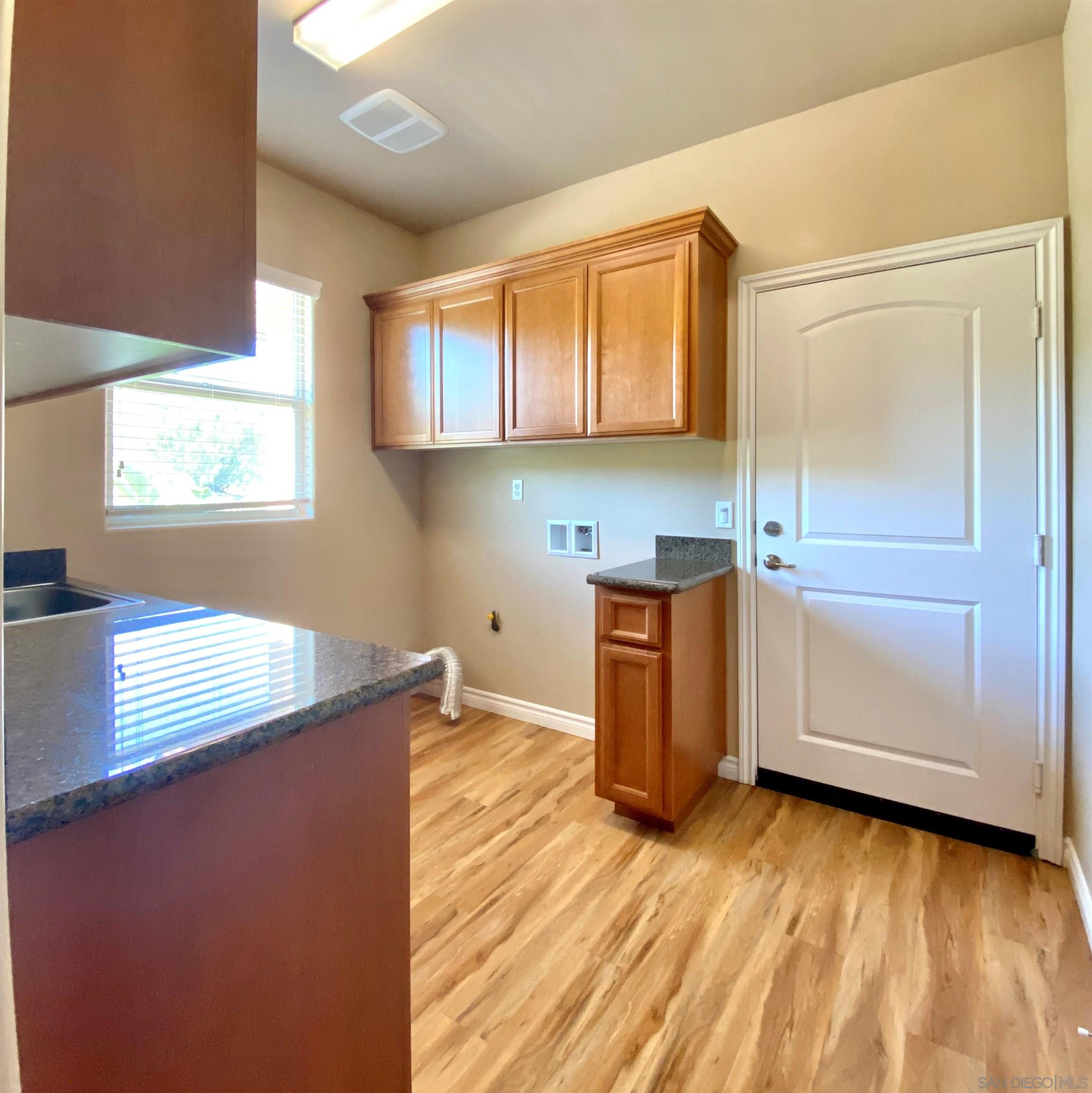 483 Alpine Trail Road Alpine, CA 91901 - Photo 25 of 42 a kitchen with wooden cabinets and a sink