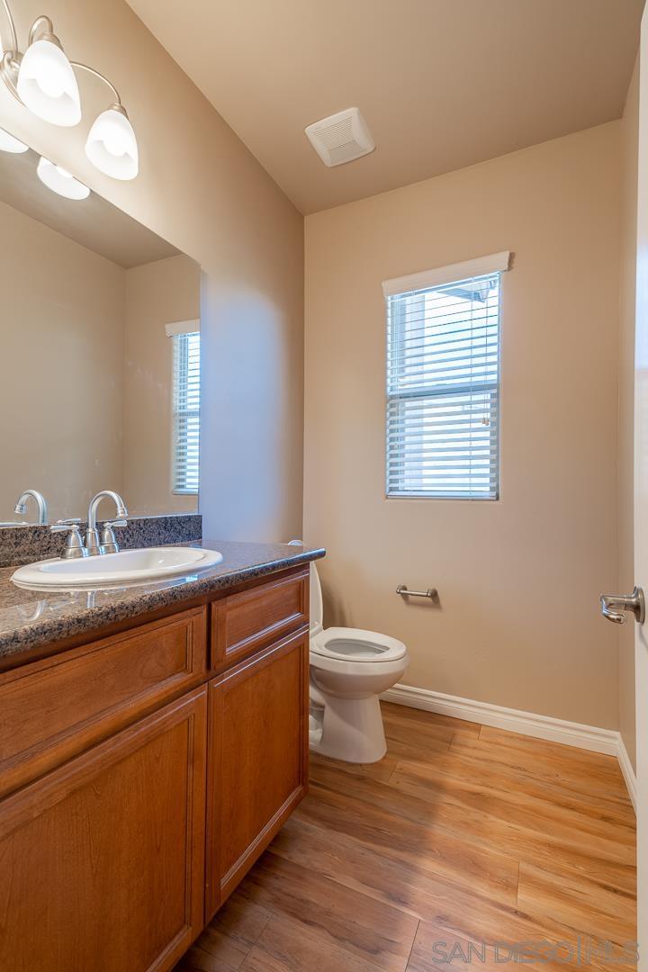 483 Alpine Trail Road Alpine, CA 91901 - Photo 27 of 42 a bathroom with a toilet sink and mirror