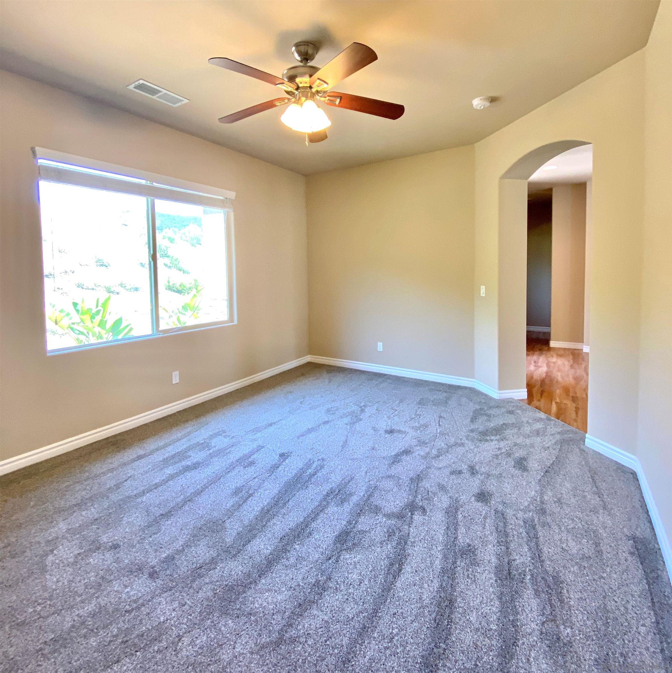 483 Alpine Trail Road Alpine, CA 91901 - Photo 29 of 42 an empty room with windows and fan