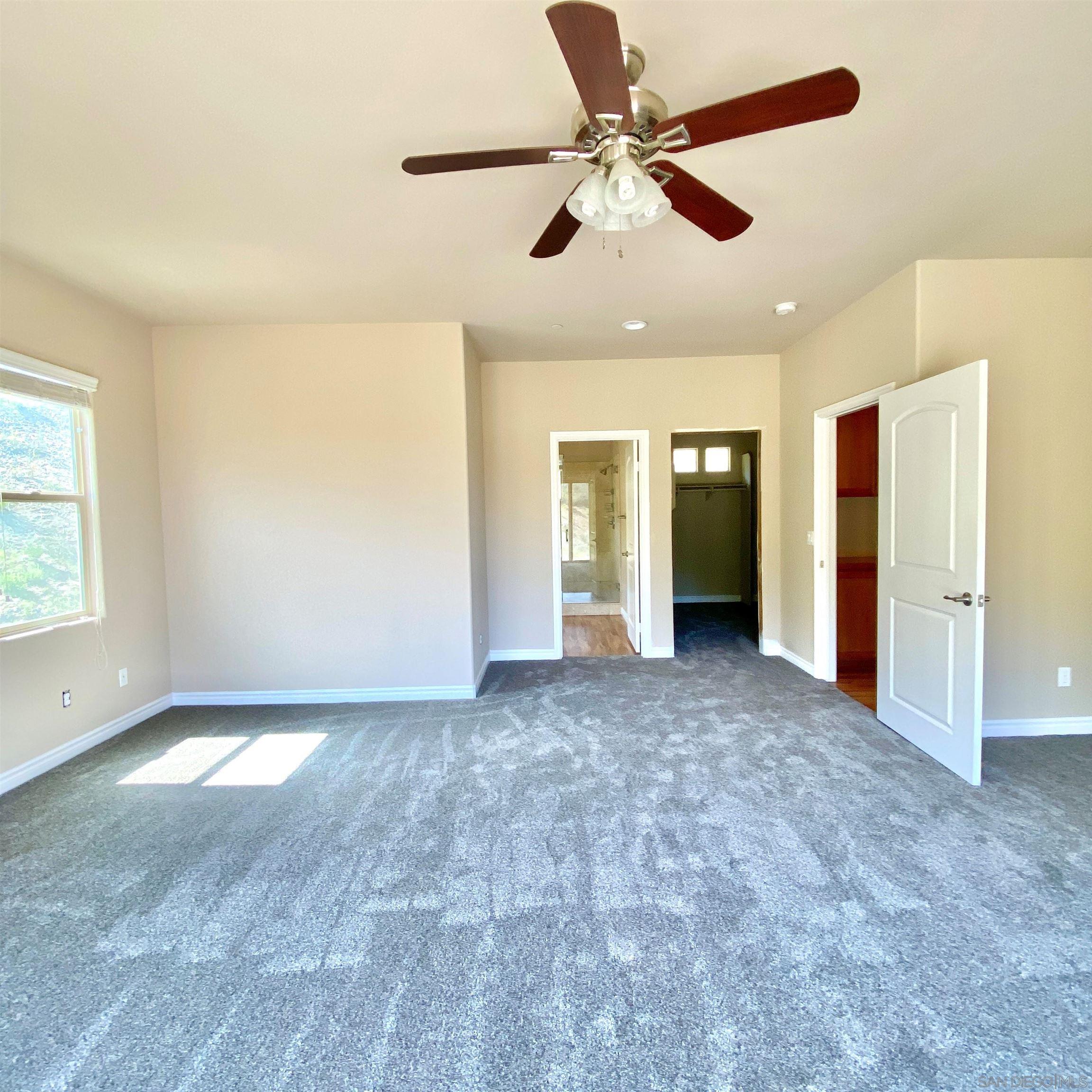 483 Alpine Trail Road Alpine, CA 91901 - Photo 31 of 42 an empty room with windows and fan
