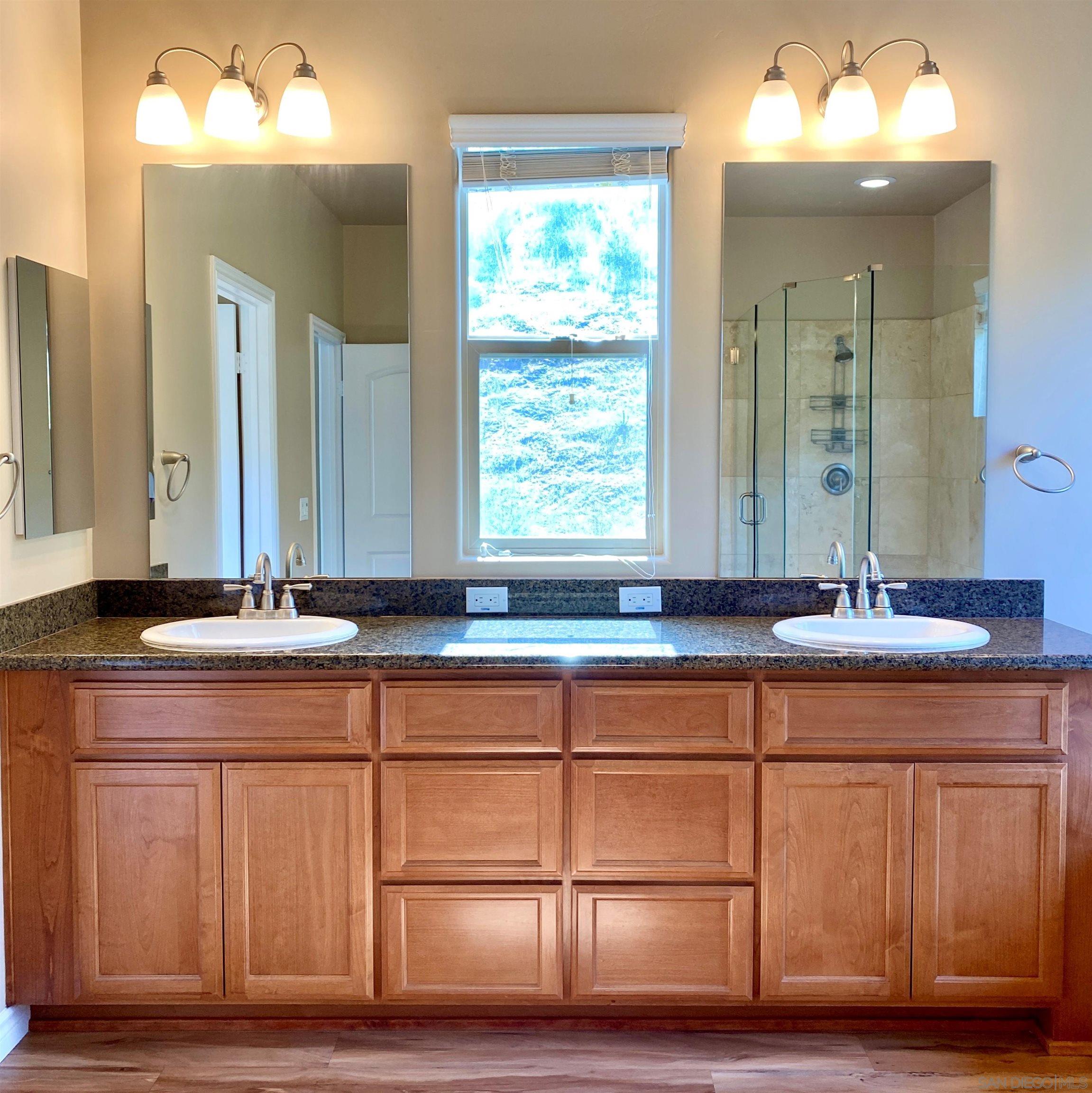 483 Alpine Trail Road Alpine, CA 91901 - Photo 33 of 42 a bathroom with a double vanity sink and a mirror
