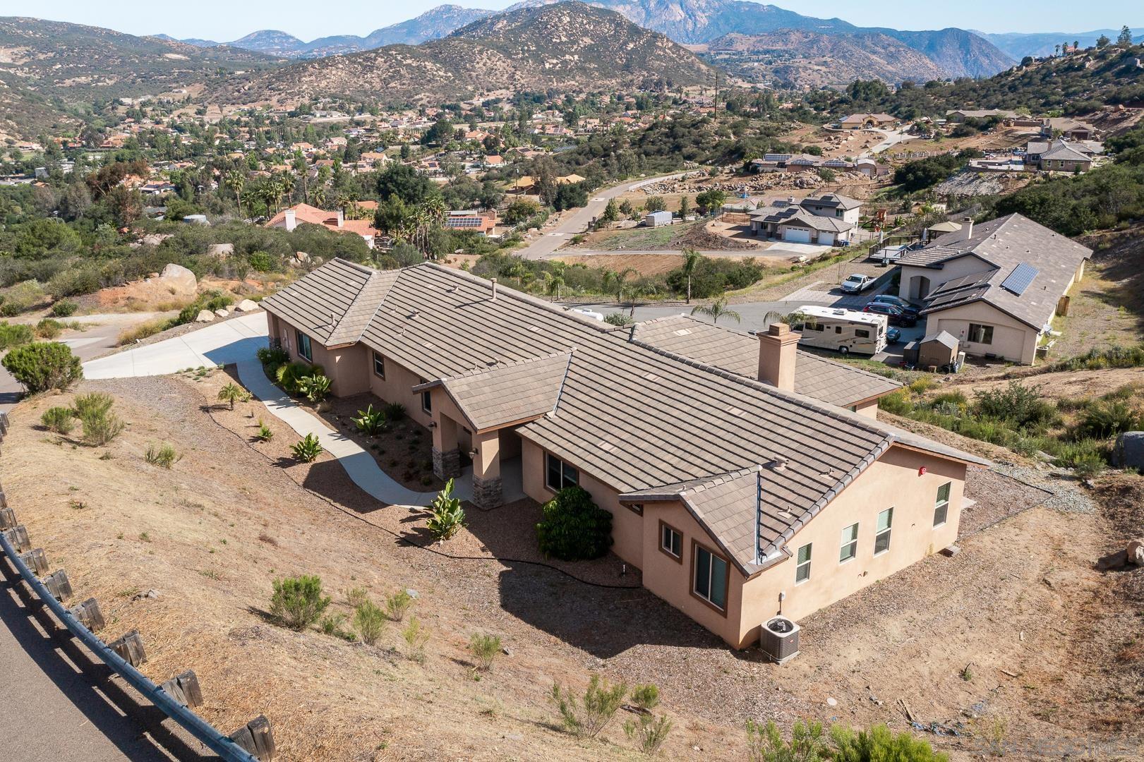 483 Alpine Trail Road Alpine, CA 91901 - Photo 5 of 42 an aerial view of a house with a yard and mountain view in back