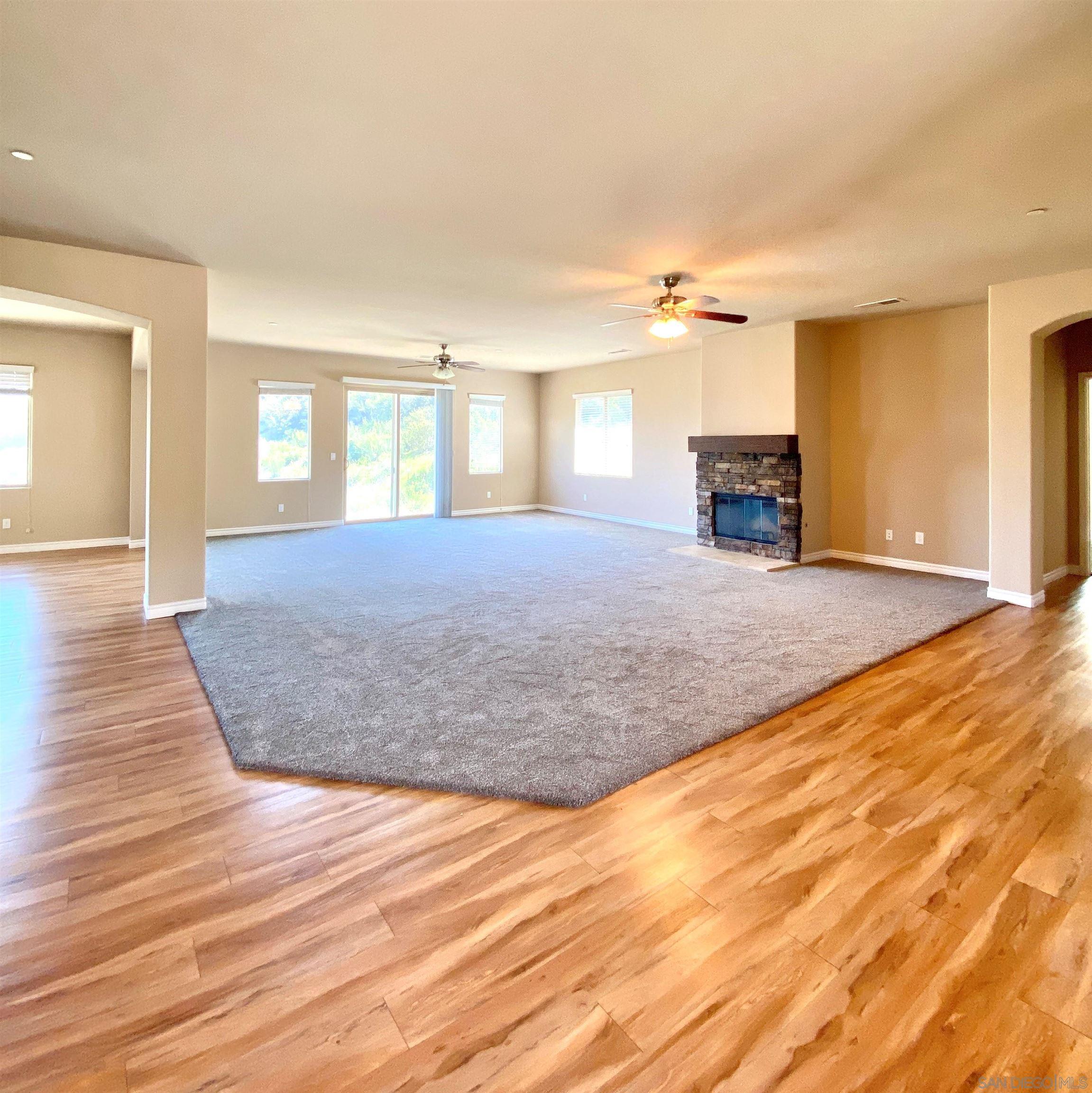 483 Alpine Trail Road Alpine, CA 91901 - Photo 9 of 42 a view of empty room with fireplace and wooden floor