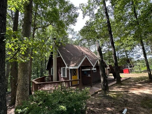 an aerial view of a house with swimming pool and trees